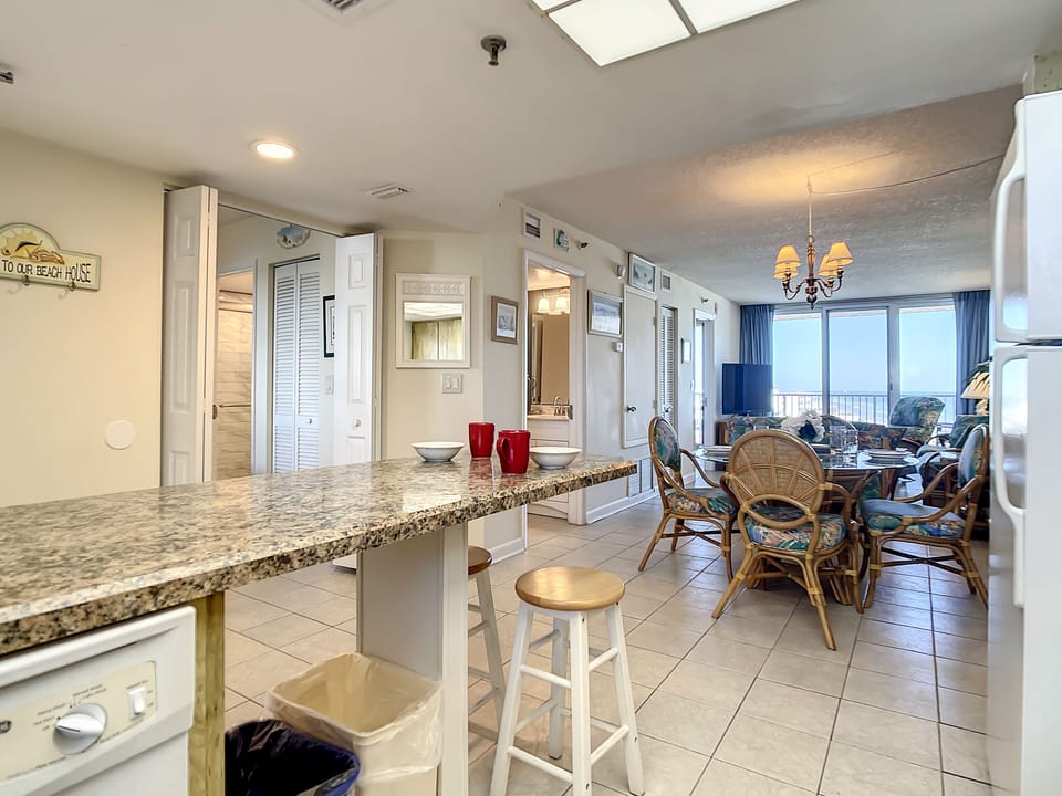 Granite countertops, breakfast bar, and open flow to the living area.