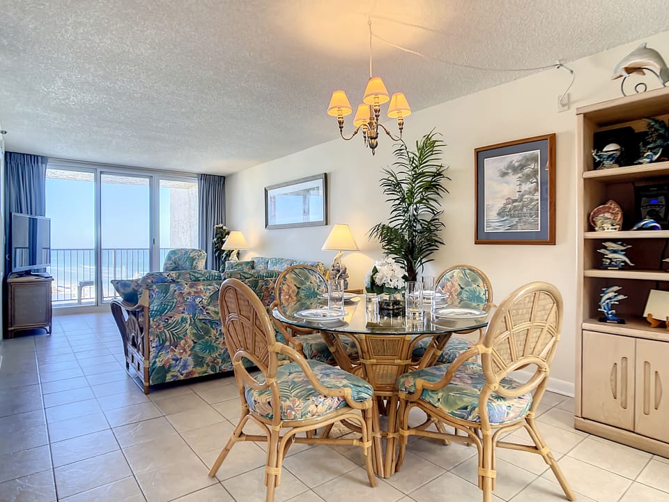Spacious living and dining area with tropical decor and oceanfront views.