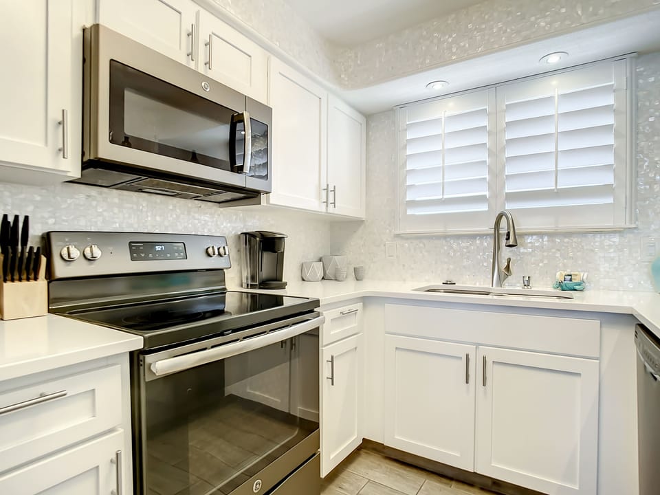 Well-lit kitchen with a spacious layout, perfect for preparing meals and enjoying the ocean-inspired decor.