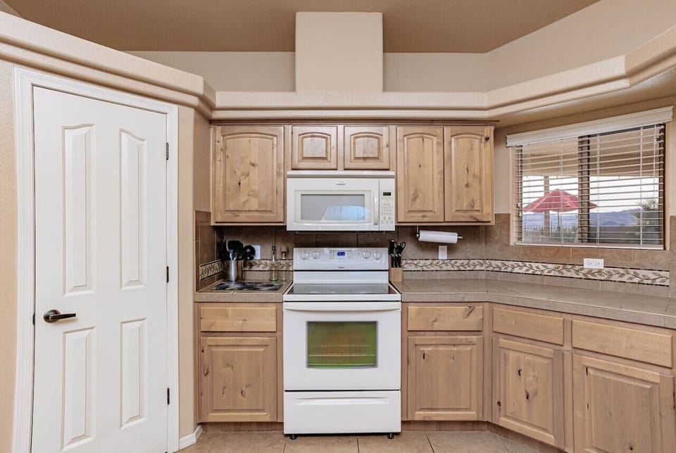 Kitchen with window looking out to backyard.