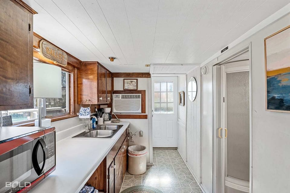 The kitchenette has dishes, a microwave, toaster, refrigerator/freezer, 2 burner electric plug in cooktop, and all utensils & dishes needed to prepare a simple meal. 
