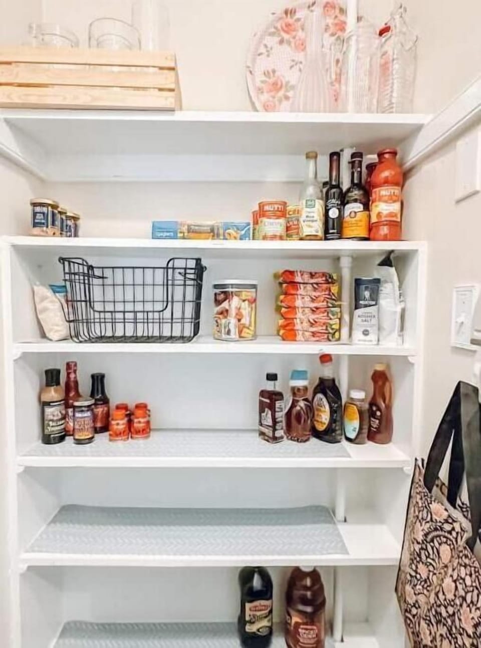 Pantry with various cooking staples, including a full spice drawer. 