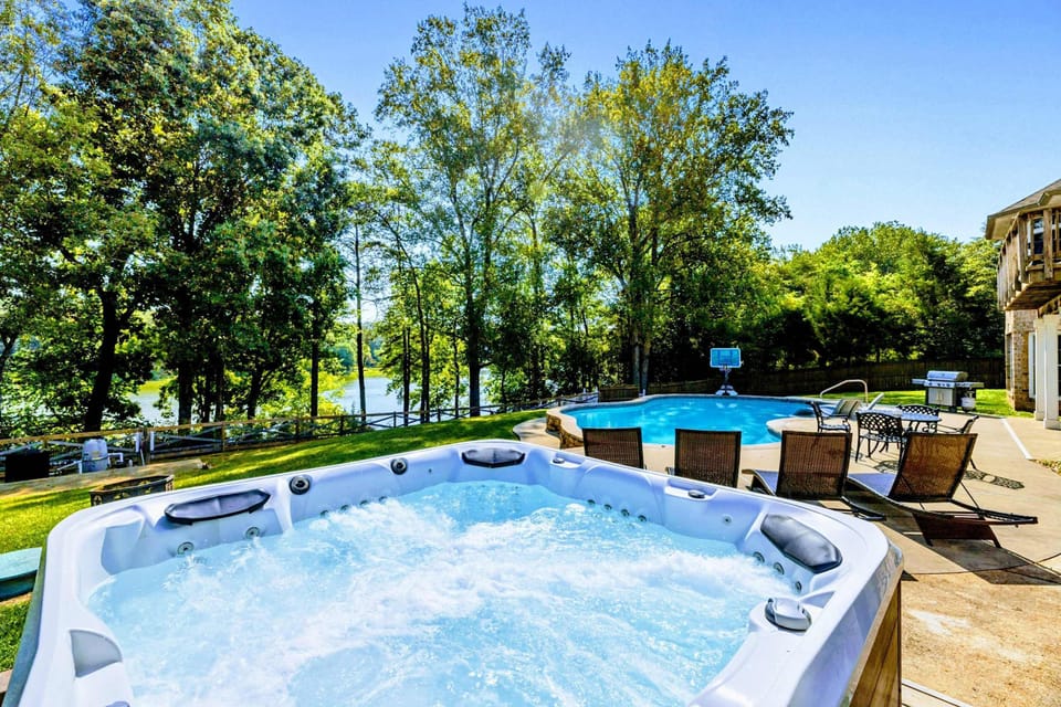 Hot Tub - Soak after a long day on the lake, with the pool and water views just beyond.