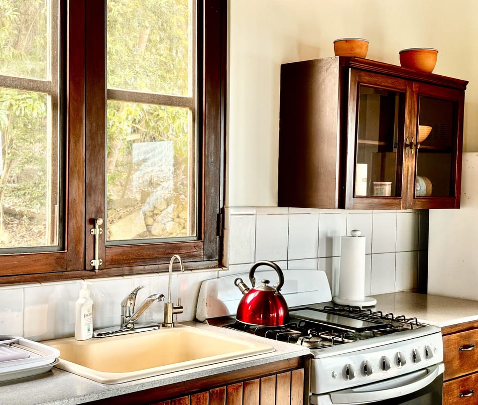 Kitchen includes 4-hob gas stove and oven amongst other appliances.