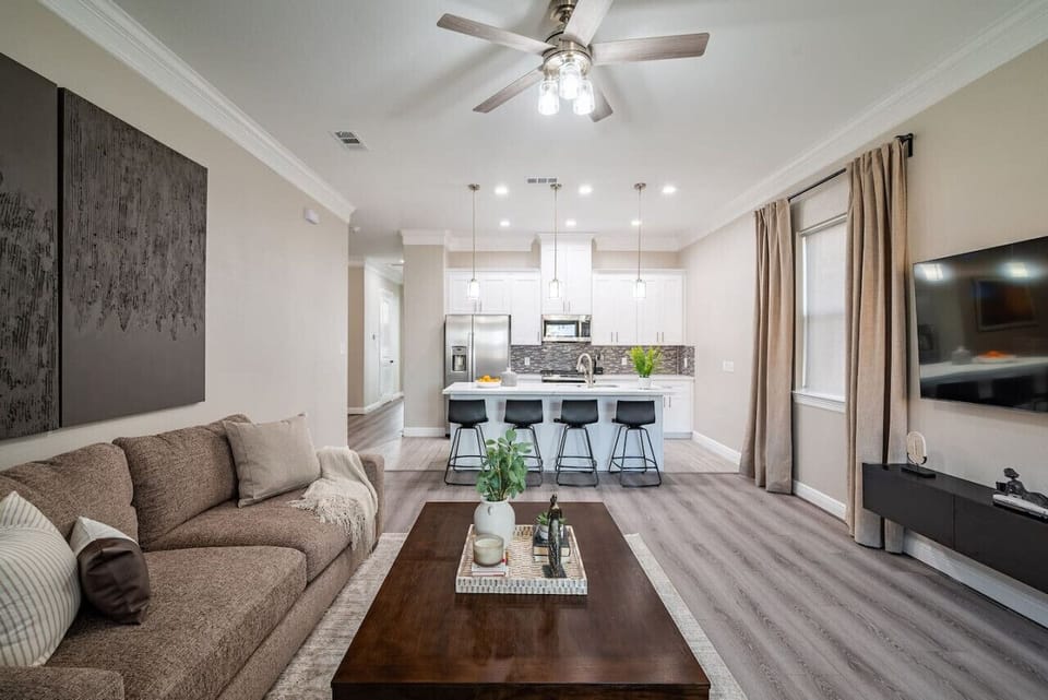 Open concept space with swivel stools that can double as dining and additional seating for the living room