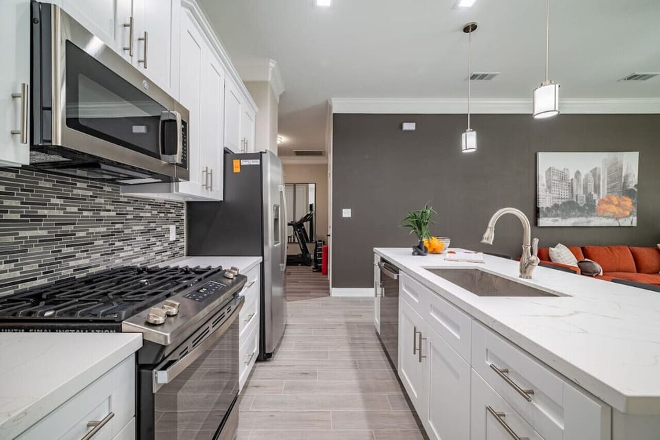 Enjoy the top quality stainless steel appliances, large deep sink, & 2 under cabinet trash cans.