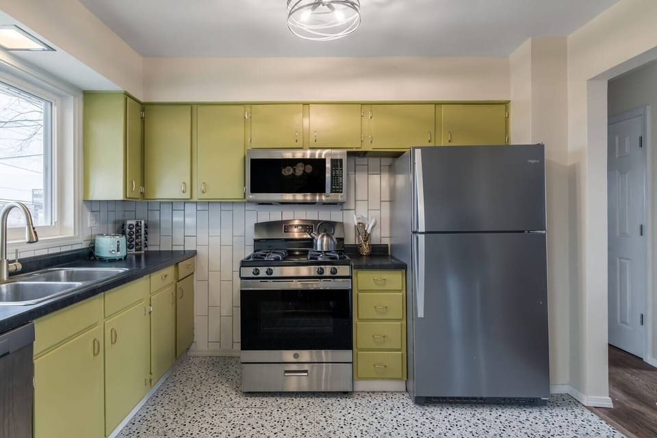 Fully equipped kitchen with stainless steel appliances, ample cabinet space, and bright natural light for easy everyday living.