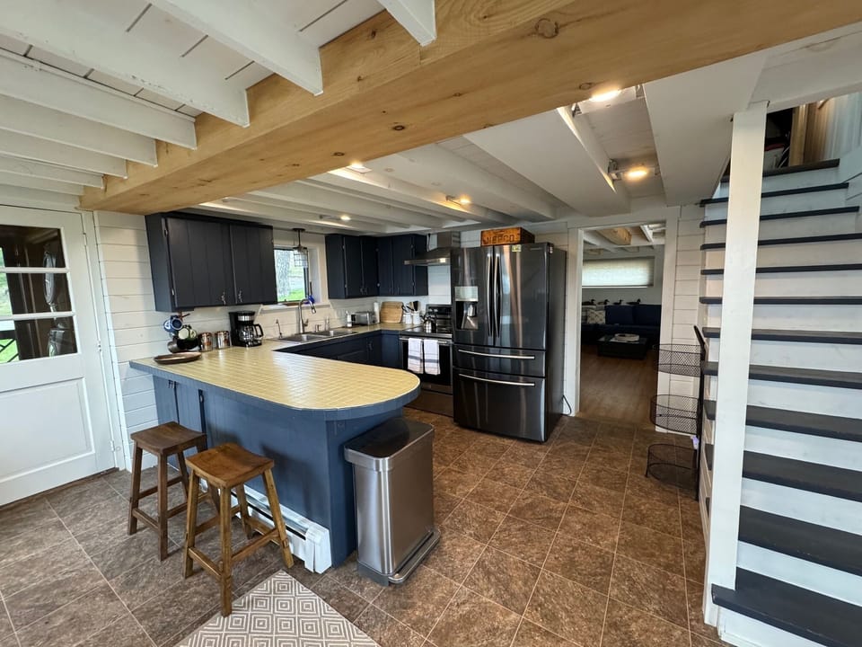kitchen with a dishwasher and large newer refrigerator and stove/oven