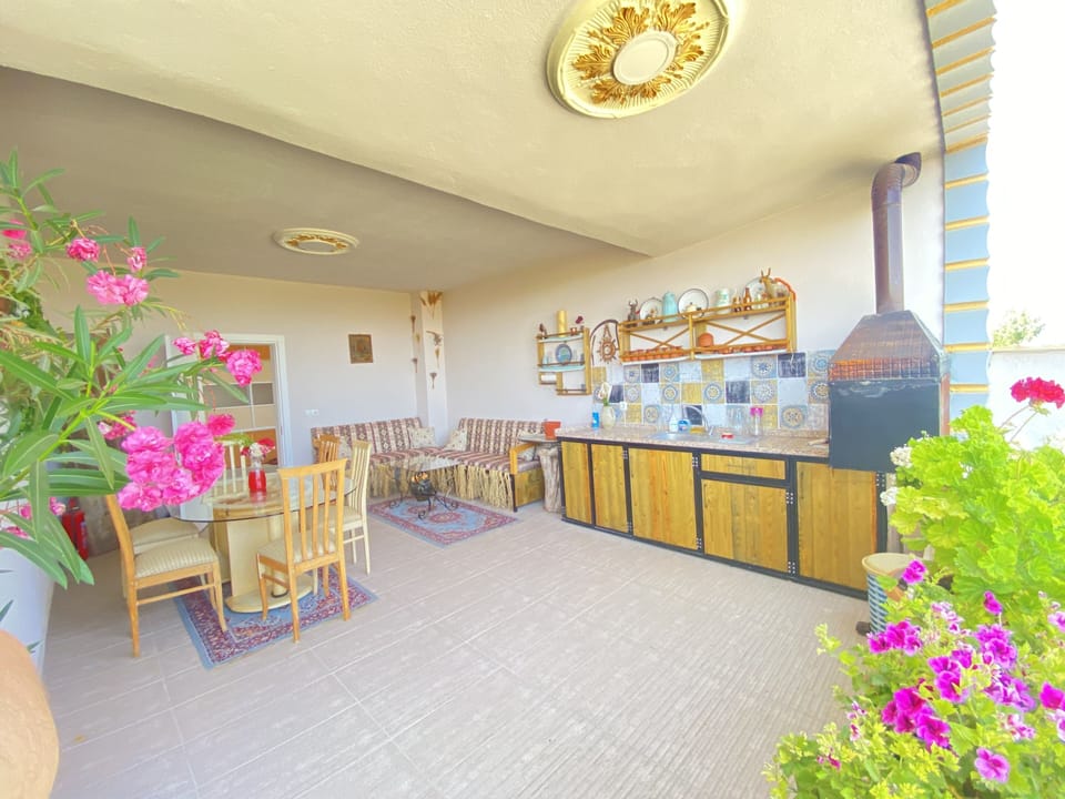 terrace with outdoor kitchen and barbecue area.