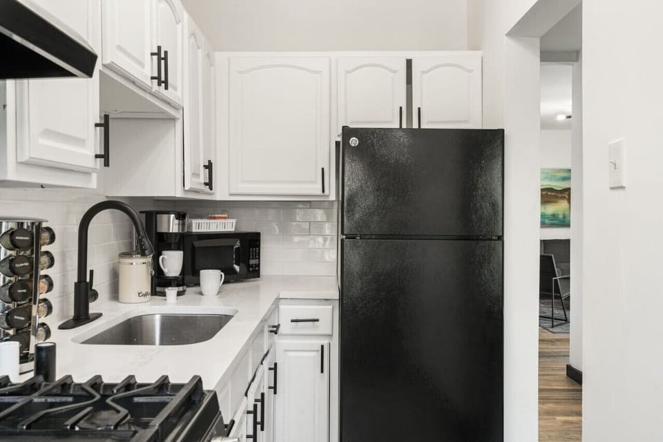 Modern stainless-steel appliances and stylish design define the kitchen