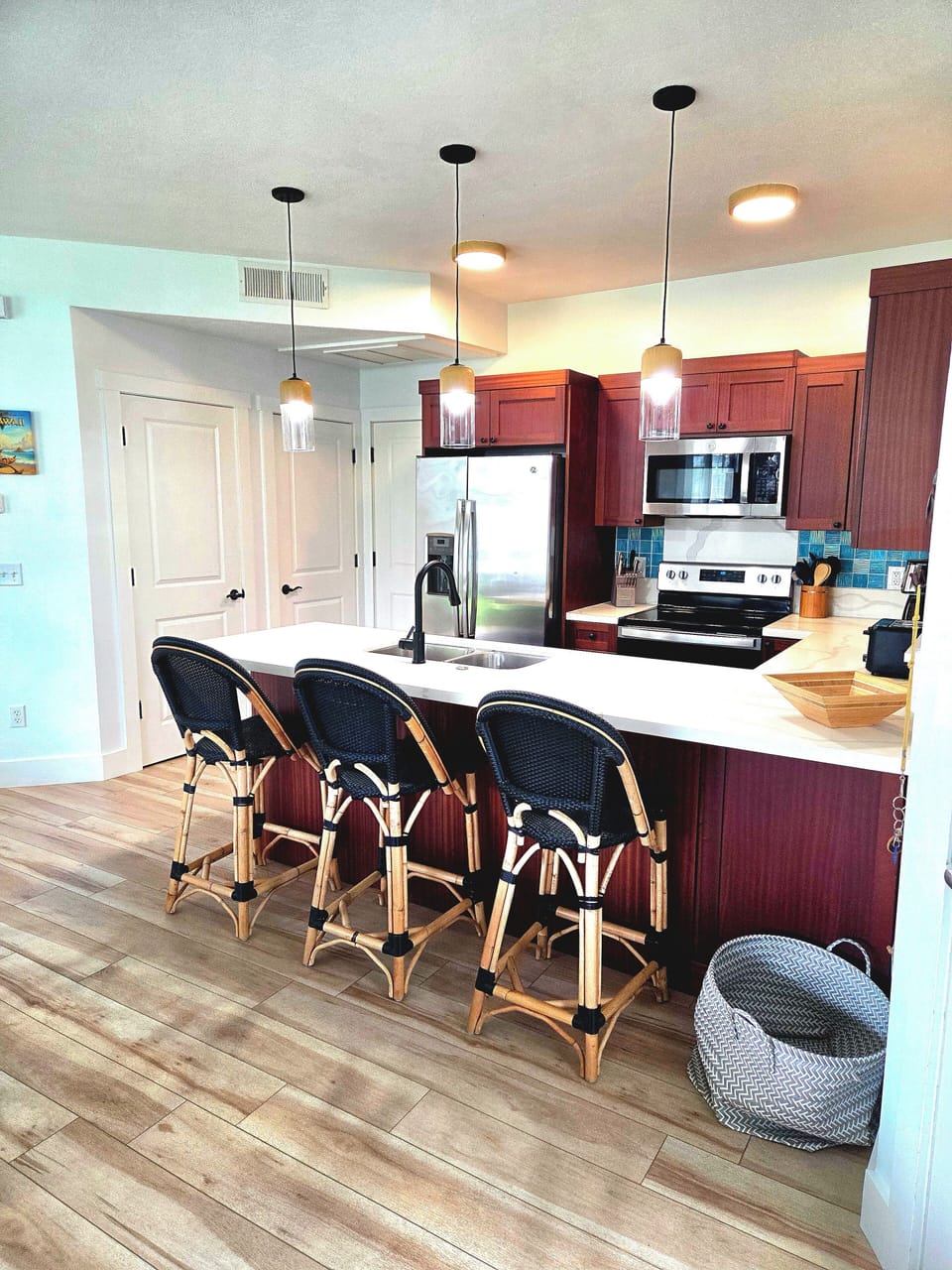 Full Kitchen, Fully Stocked, White Quartz Countertops, Aqua Backsplash Tile.