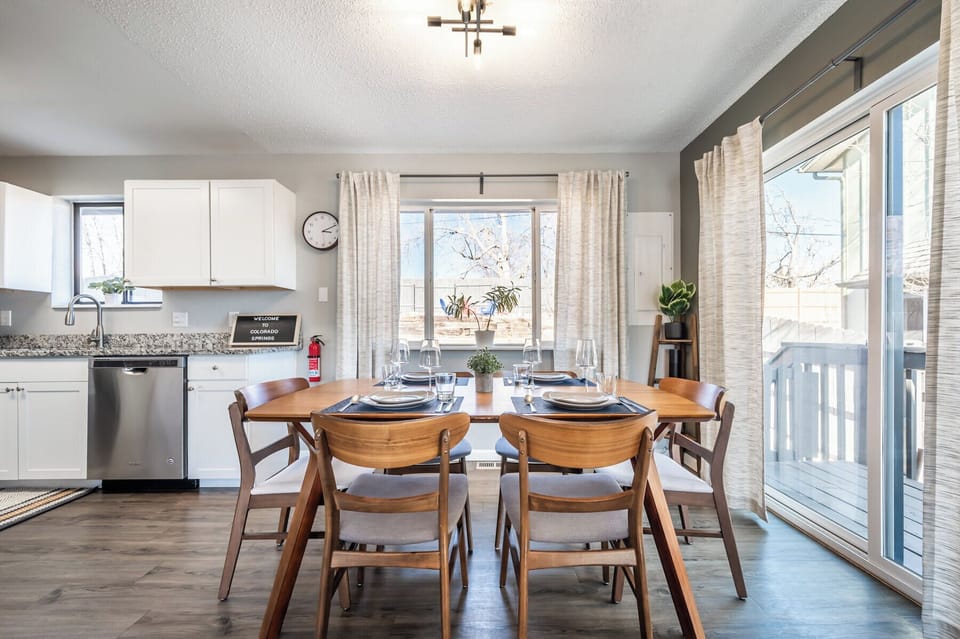 Open-concept dining area with seating for six, steps from the fully stocked kitchen and cozy living room.

