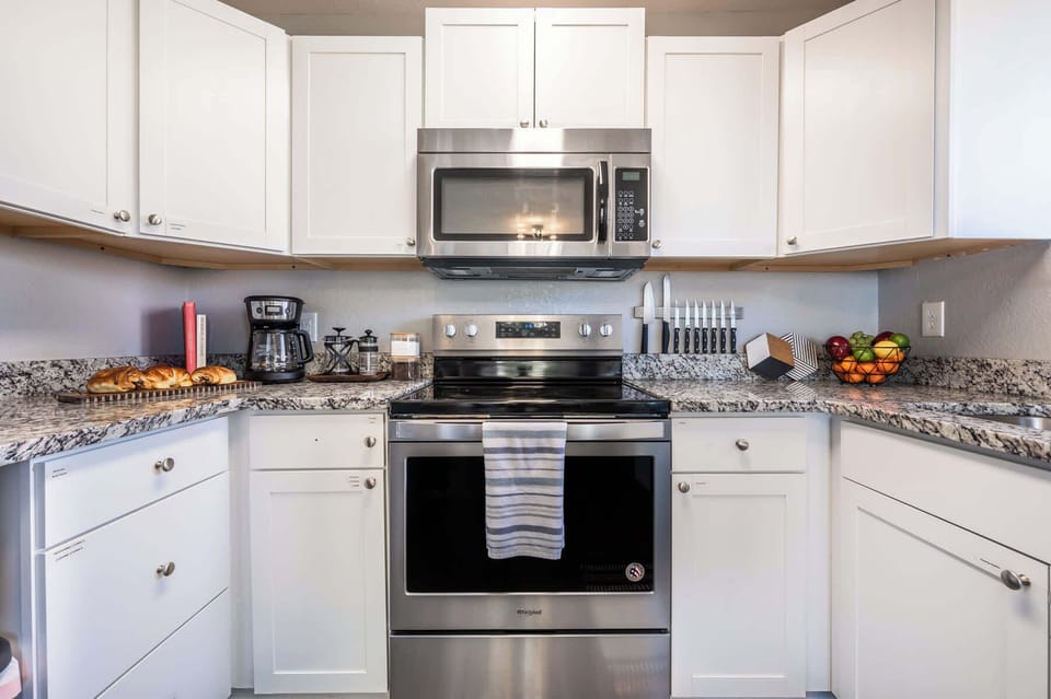 Fully stocked kitchen with granite countertops, stainless steel appliances, and a coffee station to start your day right.

