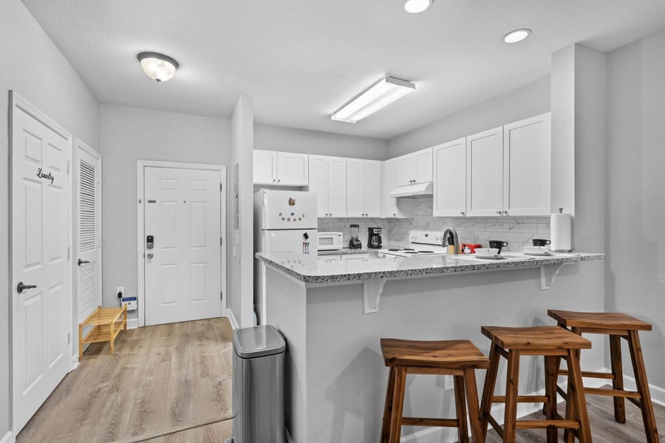 The countertop separates the kitchen from the living room.