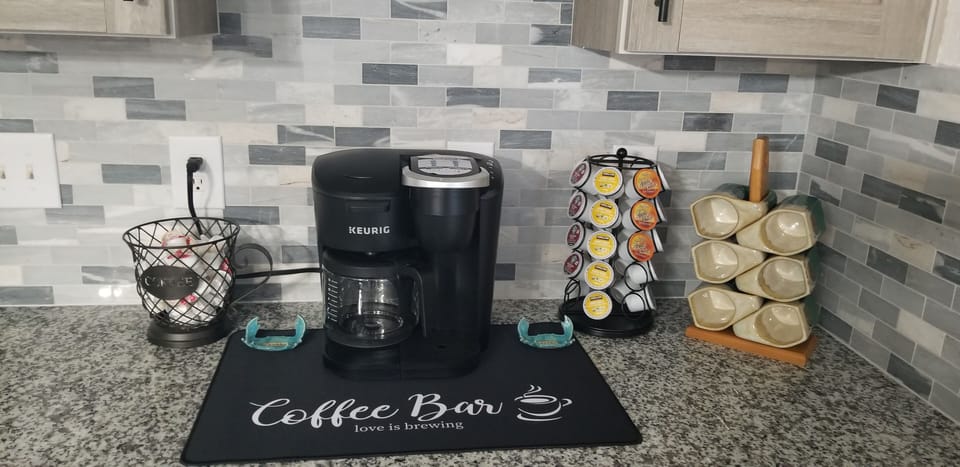 Coffee bar includes drip coffee maker and Keurig. 