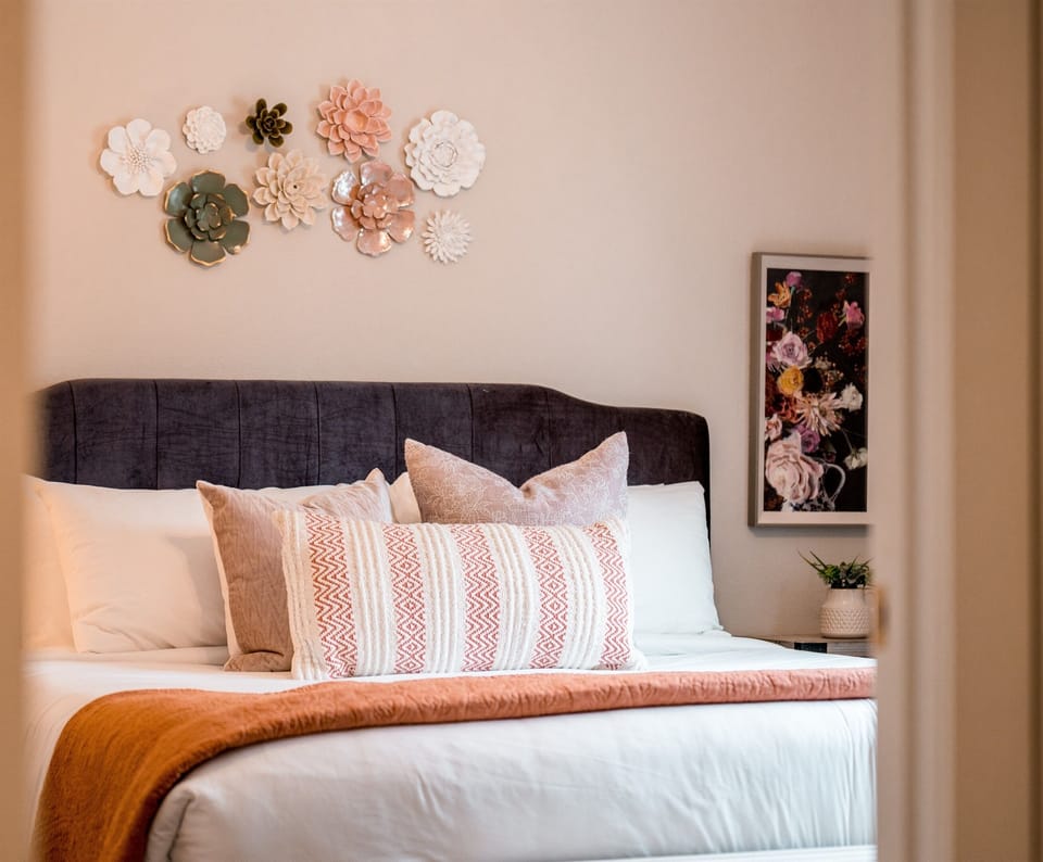 Floral Suite - a dreamy spa-inspired main floor king suite with top-tier mattresses, sumptuous white linens and topped with luxurious pillows.