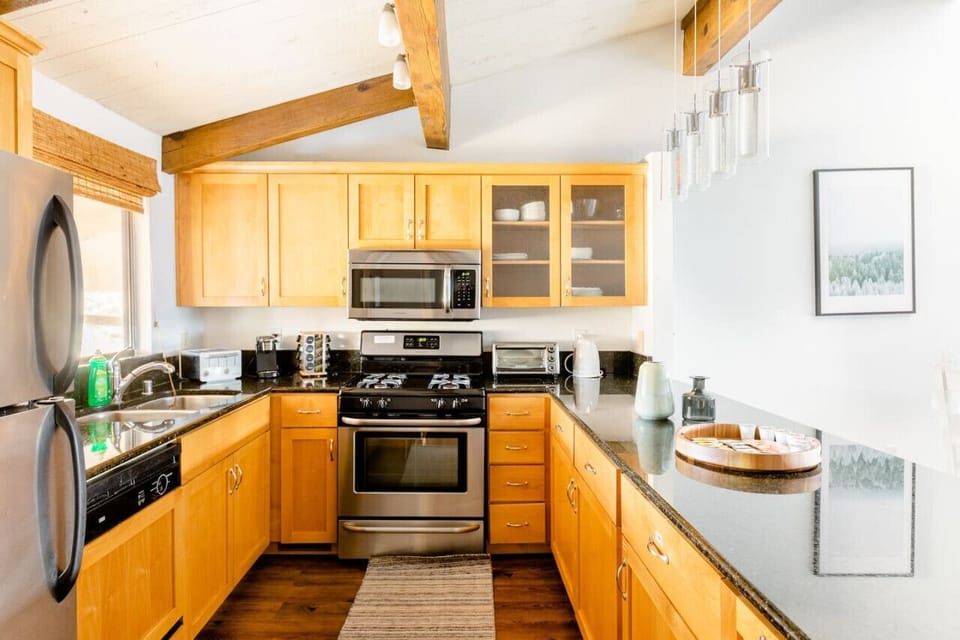 Fully equipped kitchen featuring stainless-steel appliances, granite countertops, and everything you need for cooking—pots, pans, utensils, toaster, microwave, and more. Bright, spacious, and perfect for preparing meals during your stay