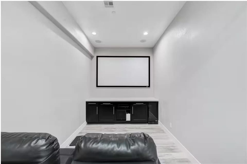 120” projector screen, surround sound, mini fridge, 5 power recliners. 