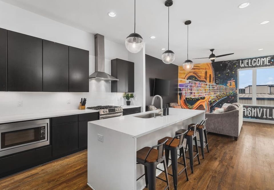 Fully-stocked chef's kitchen with a gas range, wet bar, seating for four at the island, and all the appliances / tools you could need to cook and enjoy a meal together.