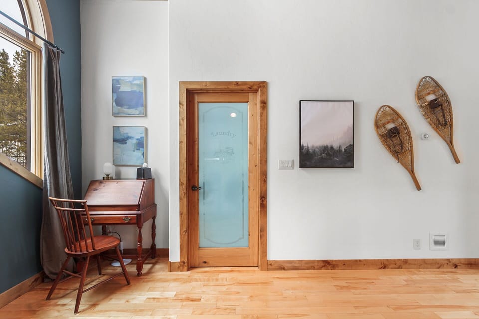 The master loft area features a vintage desk, and access to the large laundry room.