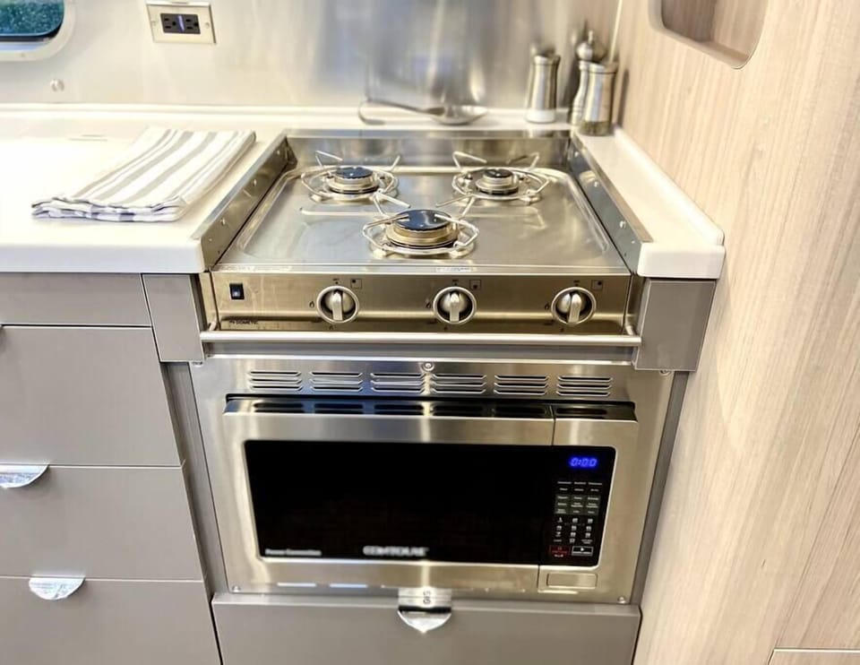 Stovetop has 3 gas burners and convection microwave/oven/air fryer