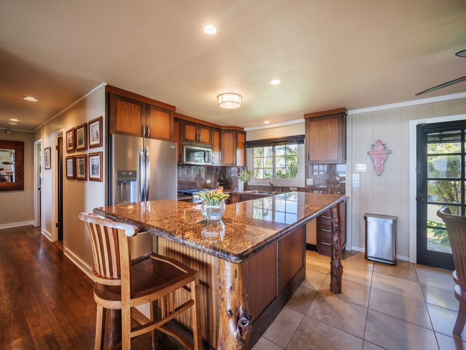 Fully-stocked kitchen with a breakfast bar for quick meals.