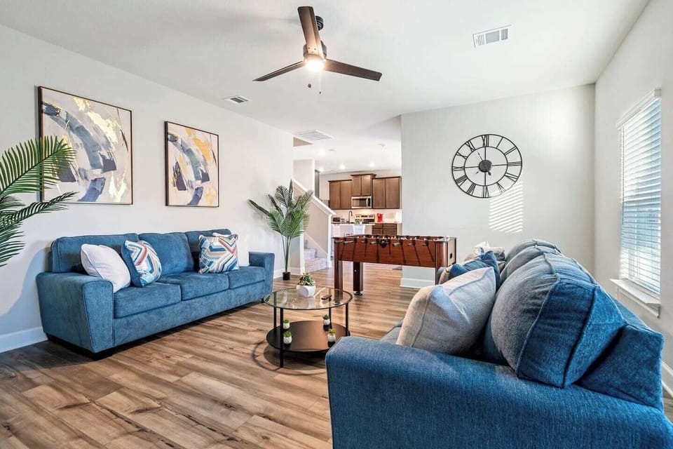 Spacious living room with modern decor and comfortable seating, perfect for relaxing after exploring local spots like Whataburger or Samurai Hibachi Express. Ideal for insurance relocations, it offers ample space for family fun and relaxation.