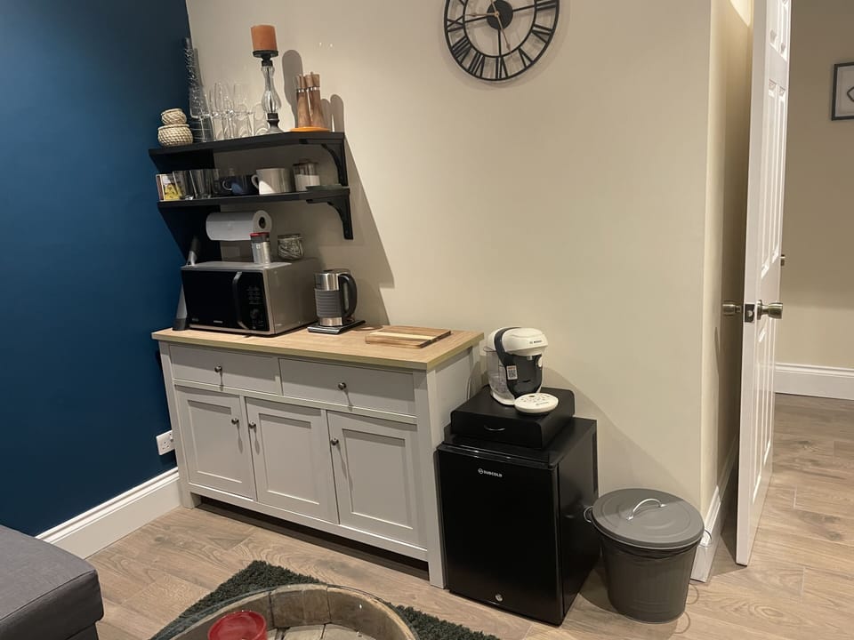The Kitchenette in the upstairs apartment has a microwave, coffee machine, kettle and fridge.,