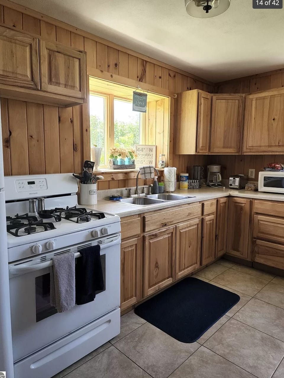 Cabin kitchen has full fridge and gas range.