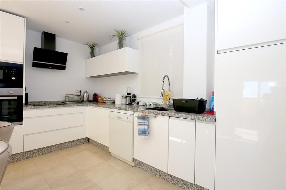 Modern open kitchen is fully fitted with all the appliances