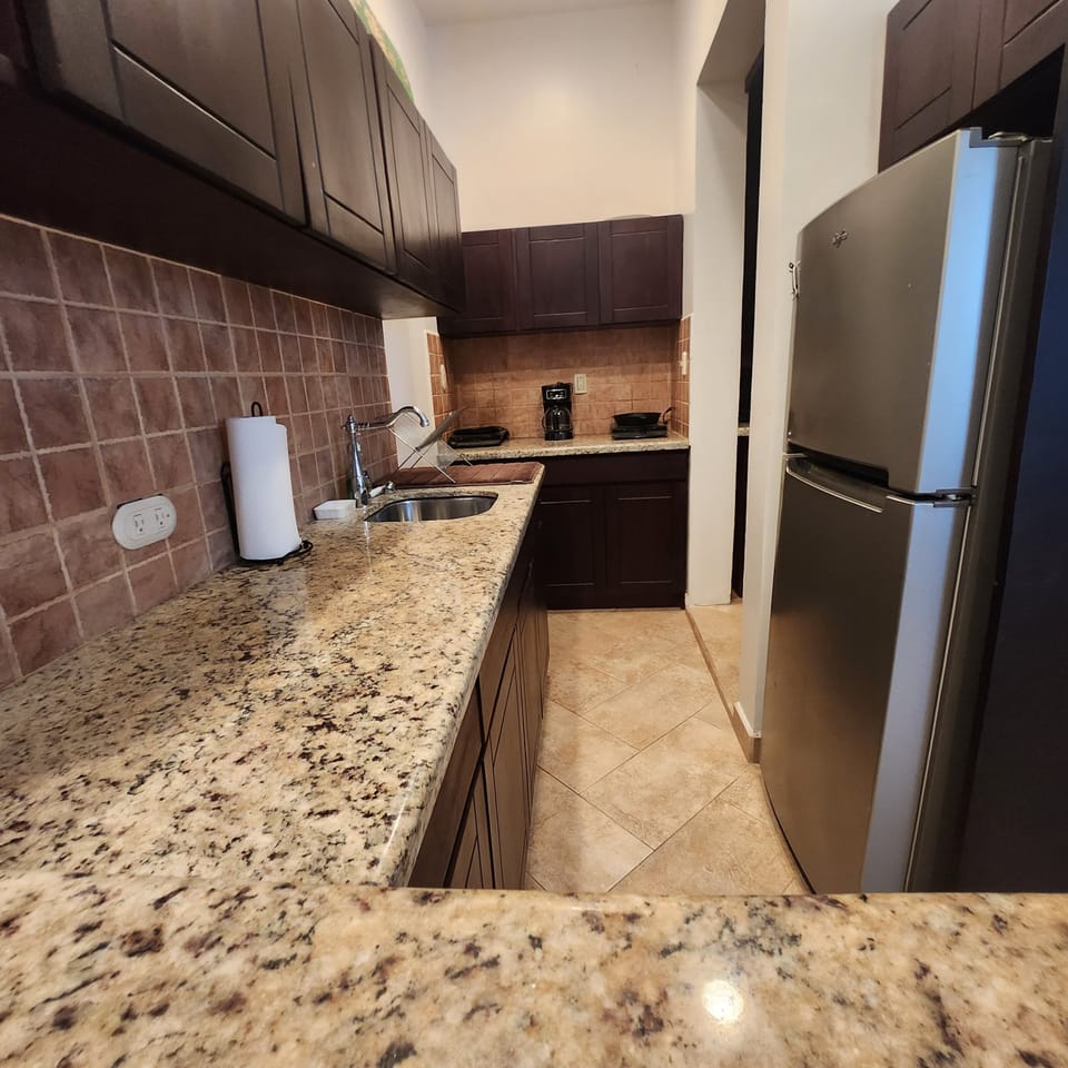 Galley kitchen, well furnished. 