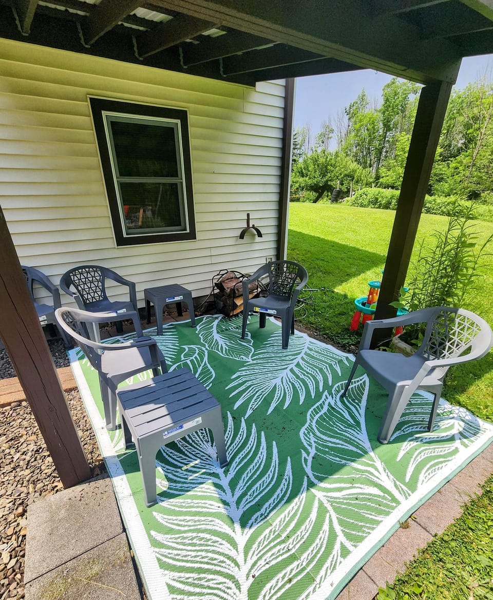Covered back patio with small firepit. Keep an eye on the kids while relaxing. 