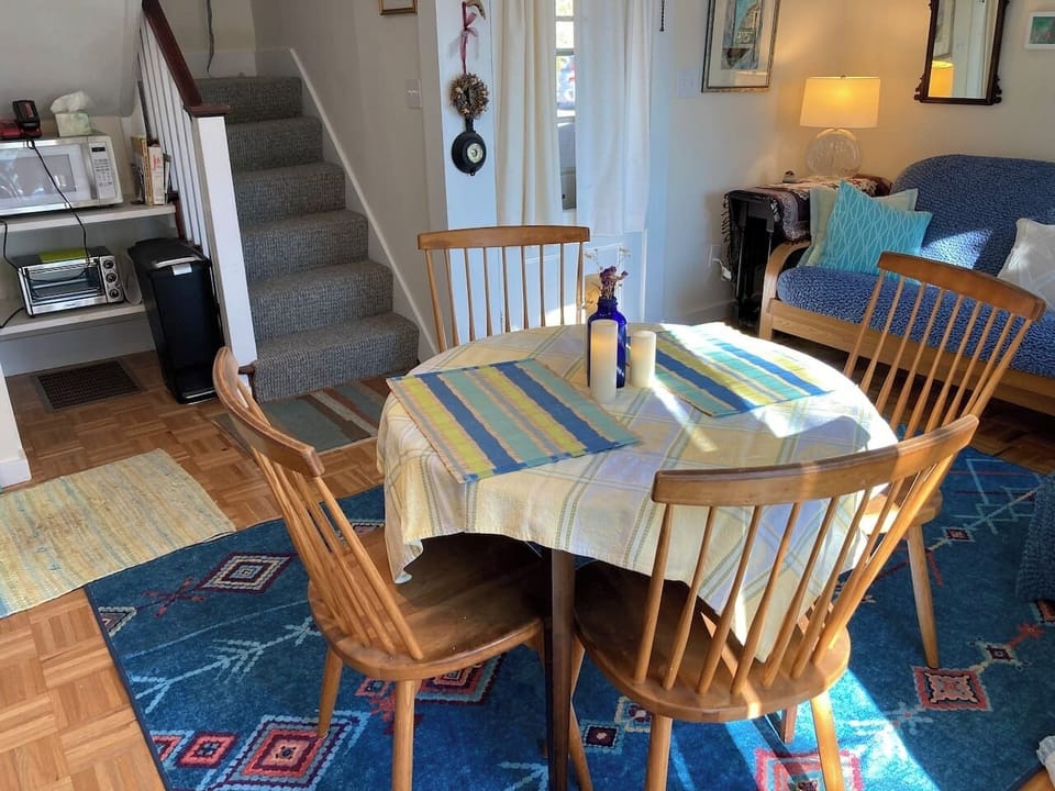 Dining area, showing micorwave and toaster oven area, as well as stairs to bedroom.