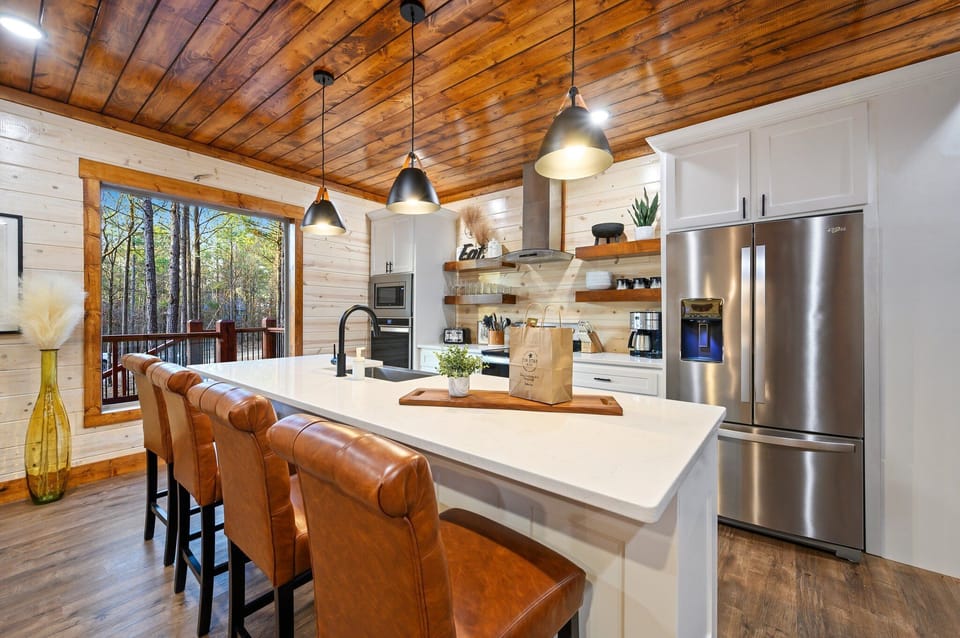 The kitchen also has views of the towering pines outside.