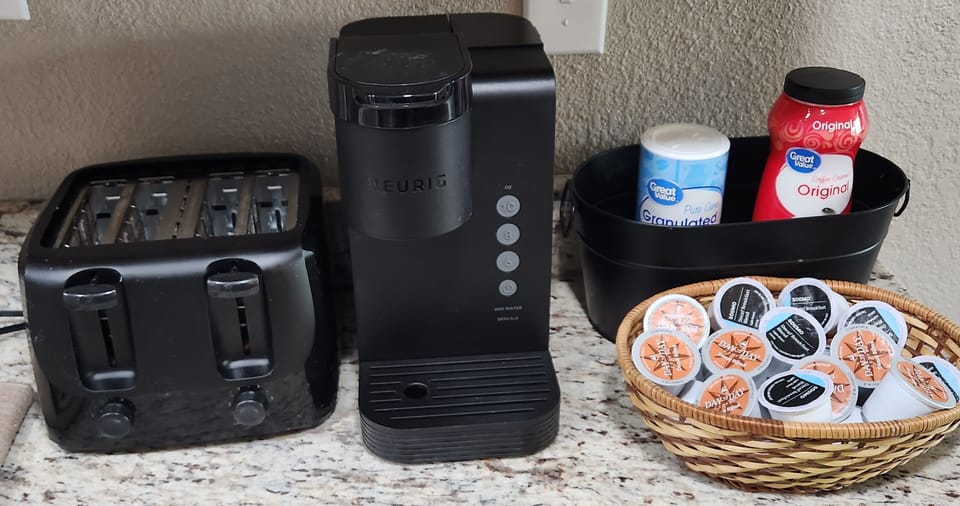 Single server KEURIG. coffee kcups, sugar, powdered creamer & 4 slice toaster.