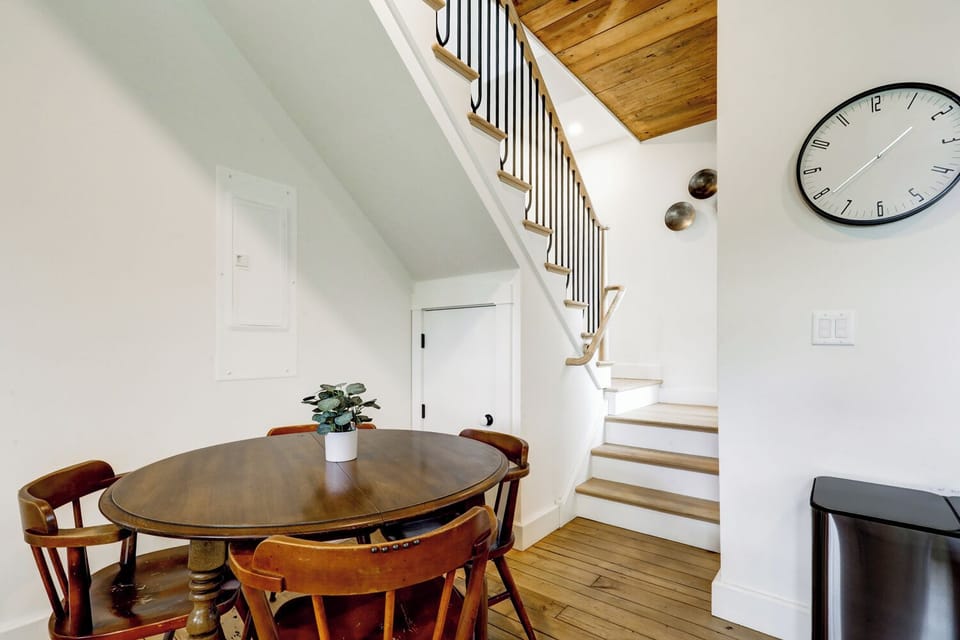 Dining table and stairs leading up to second floor with 2 bedrooms/2 bathrooms 