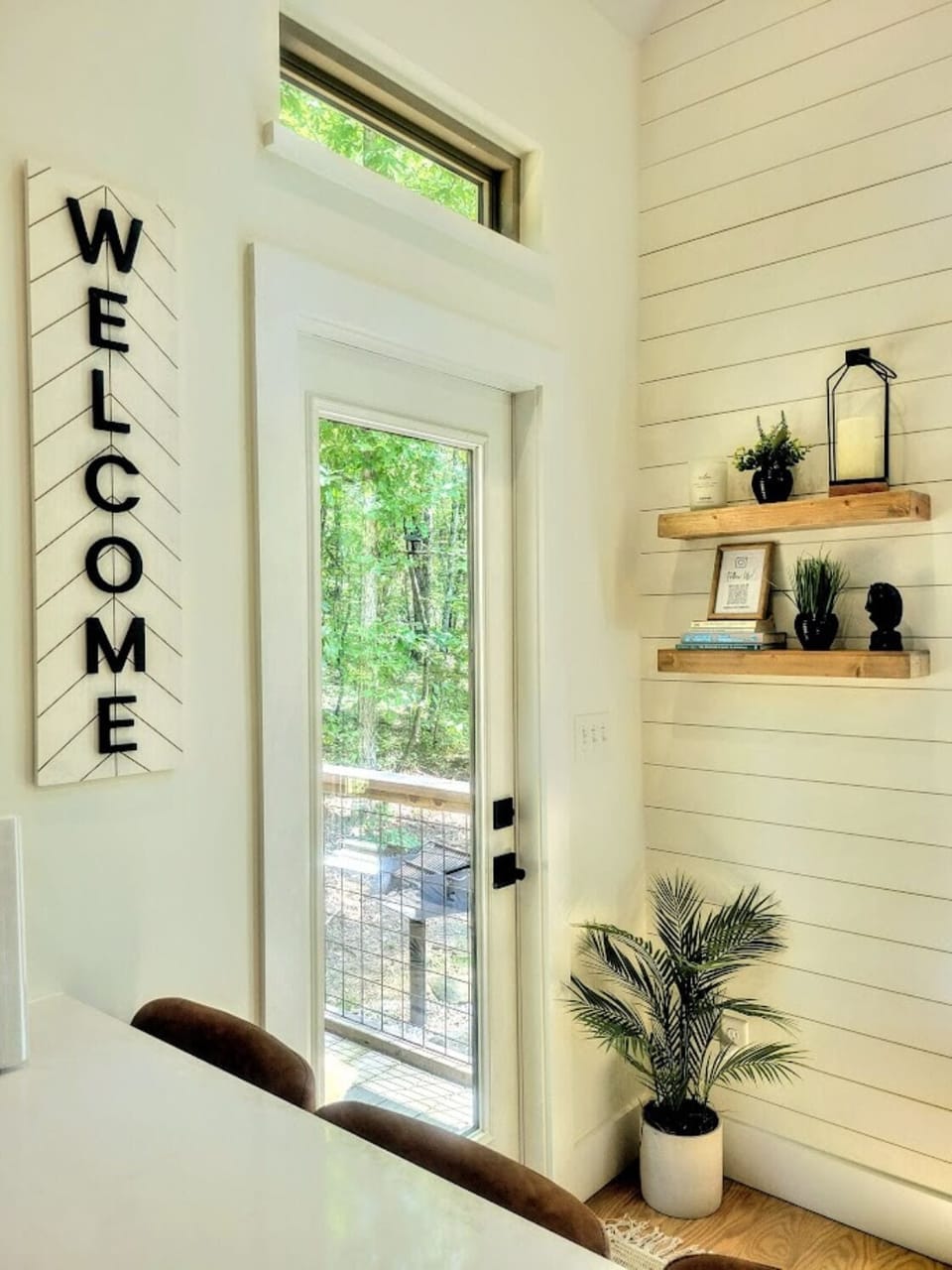 Door to back porch. Charcoal grill and private back yard.