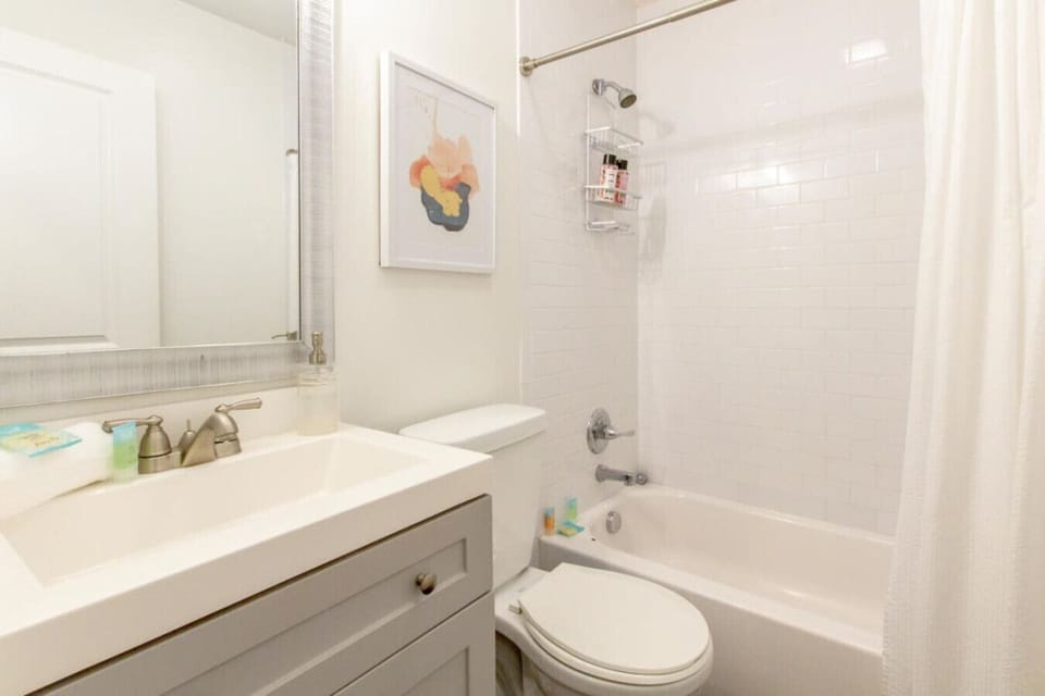 Bright bath featuring framed art and a comfortable, classic layout.