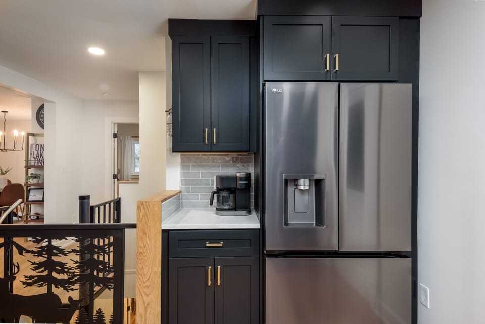 Kitchen with coffee bar open to the spiral staircase 