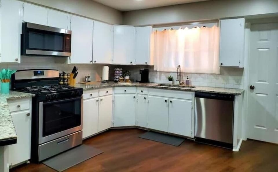 Large bright kitchen with granite counter top.