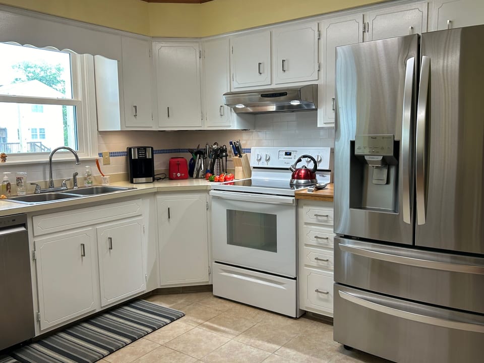 Spacious, well-stocked family-sized kitchen. 