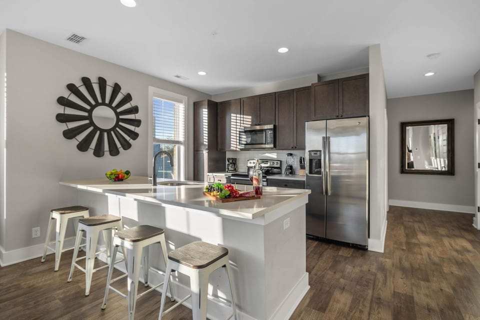 Fully equipped kitchen stocked with your basic cooking essentials, stainless steel appliances, and breakfast bar seating.