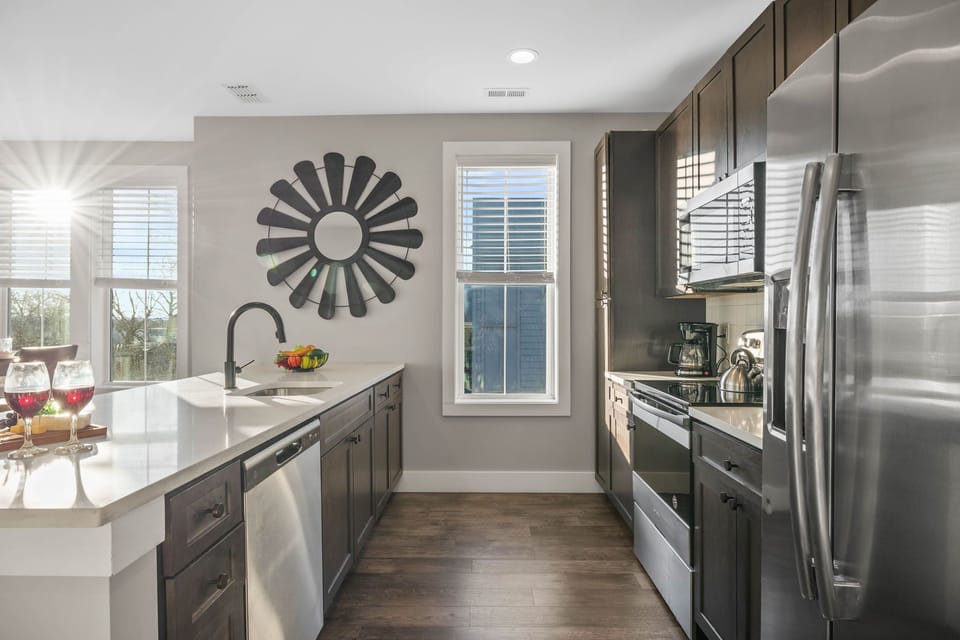 Fully equipped kitchen stocked with your basic cooking essentials, stainless steel appliances, and breakfast bar seating.