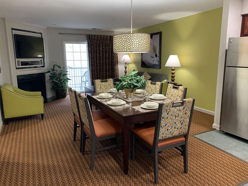 Dining Area with a table for six. Living area features a sleeper sofa for two.