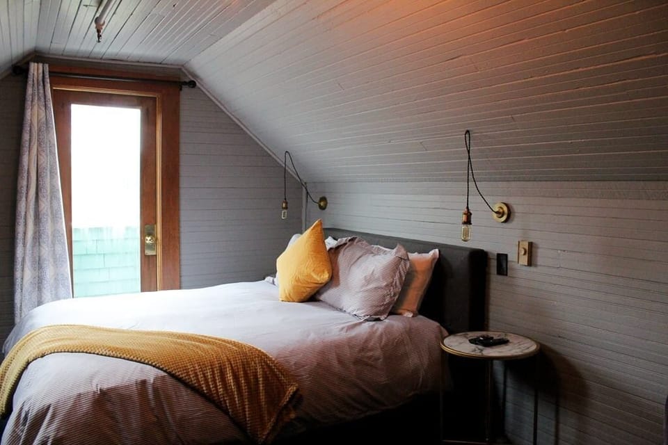 Relax into a serene attic bedroom with calming, modern touches.