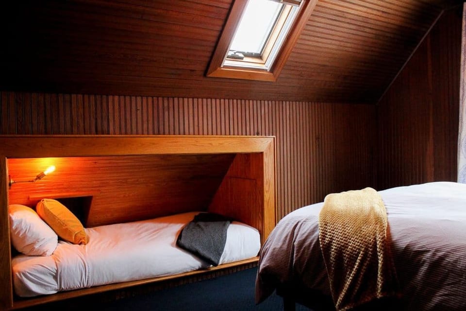 Curl up in a cozy nook bed under skylight views.
