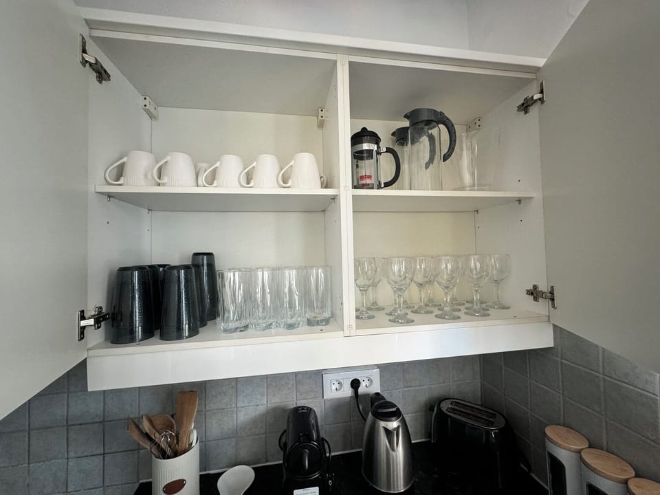 Kitchen is stocked with all the cups, pots pans needed to make an amazing meal!