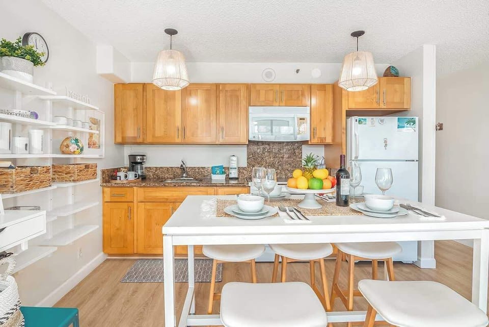Fully equipped kitchen with full-size appliances, plus dining table with 5 bar stools, cabinets, and shelves for your kitchen utensils.