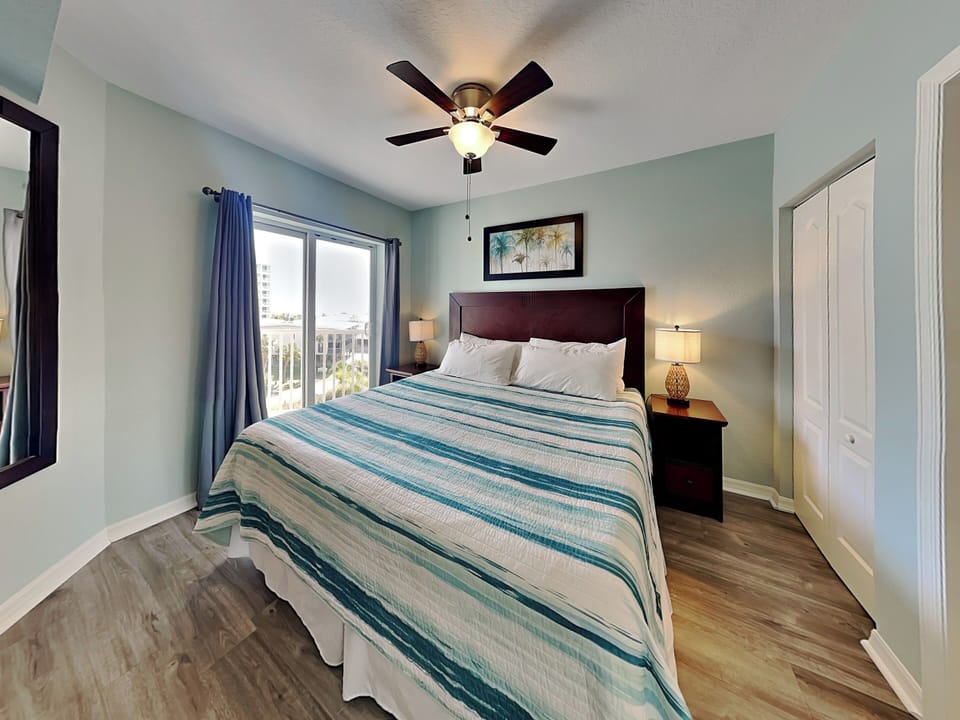 Primary Bedroom - King Bed, Smart TV, Balcony Access + Ensuite Bathroom