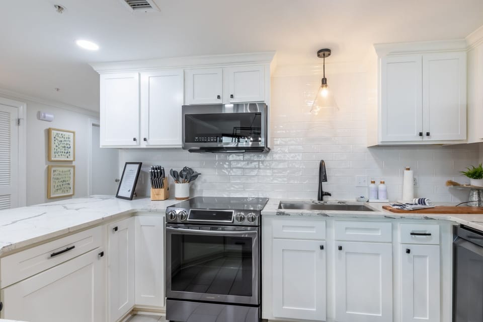 Prepare meals in this elegant kitchen with modern stainless appliances, elegant fixtures, and a stylish design
